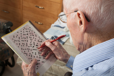 Man doing crossword puzzle